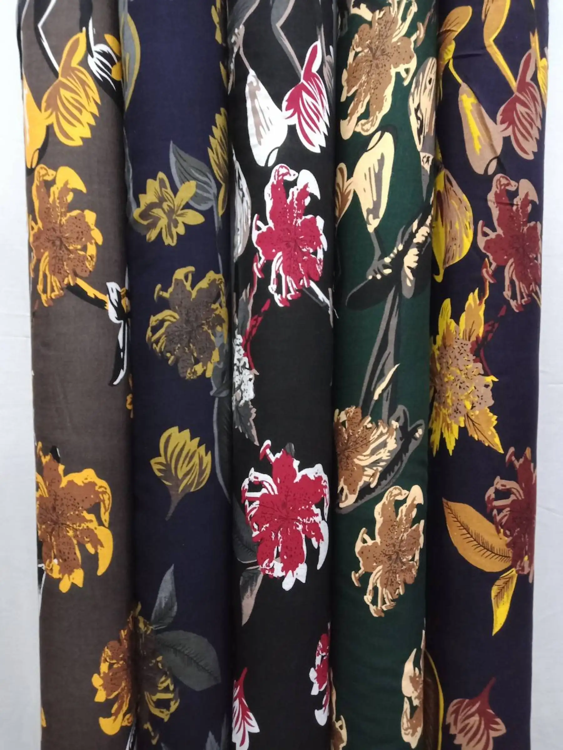 Floral8 Collection, all colorways shown together. Large hand-painted lilies and tulips scatter across the cloth on slender leafy stems.
