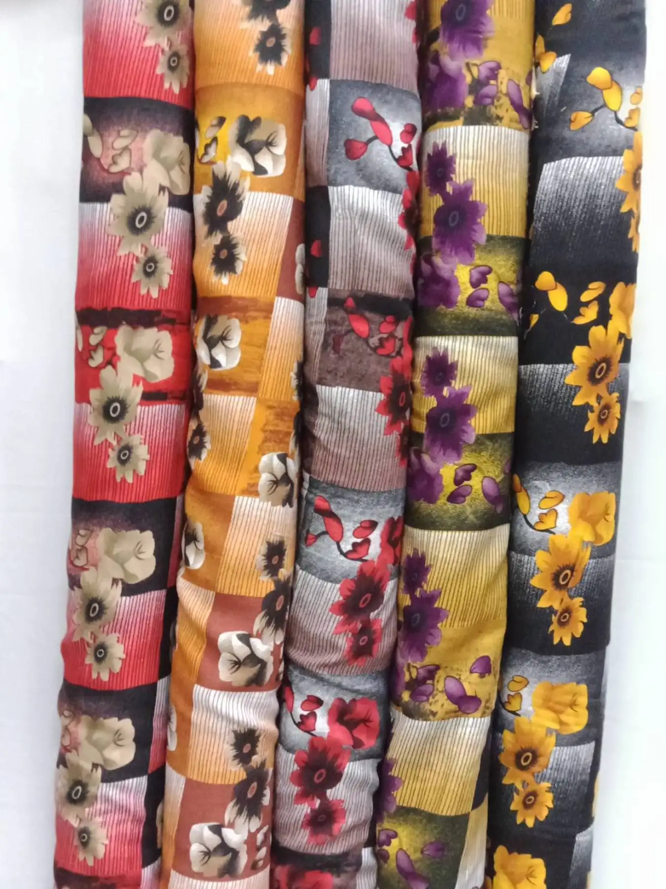 Floral16 Collection, all colorways shown together. Bold open-faced blossoms with dark centers scatter across a banded, horizontally striped ground.