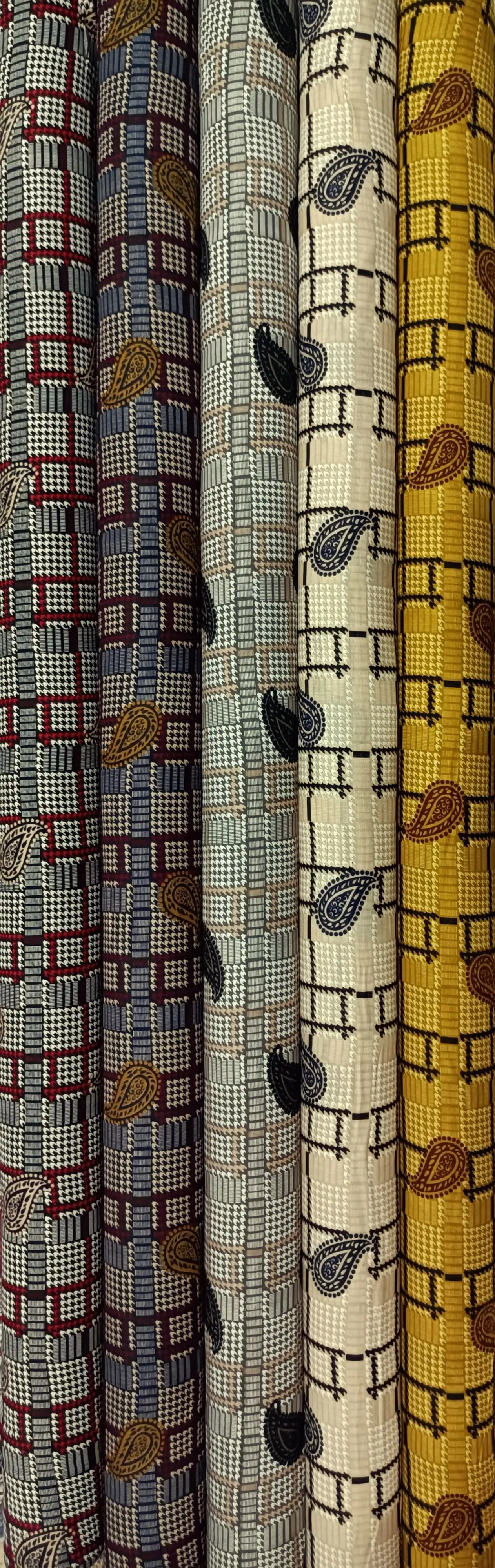 Geometric7 Collection, all colorways shown together. A fine houndstooth and glen plaid check is crossed by a slim windowpane grid and scattered with small paisley teardrop motifs.