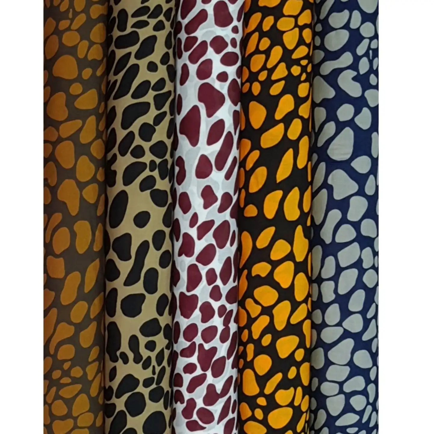Stripes and Dots4 Collection, all colorways shown together. Irregular rounded blotches pack together in an organic pebble, giraffe-spot pattern across the cloth.