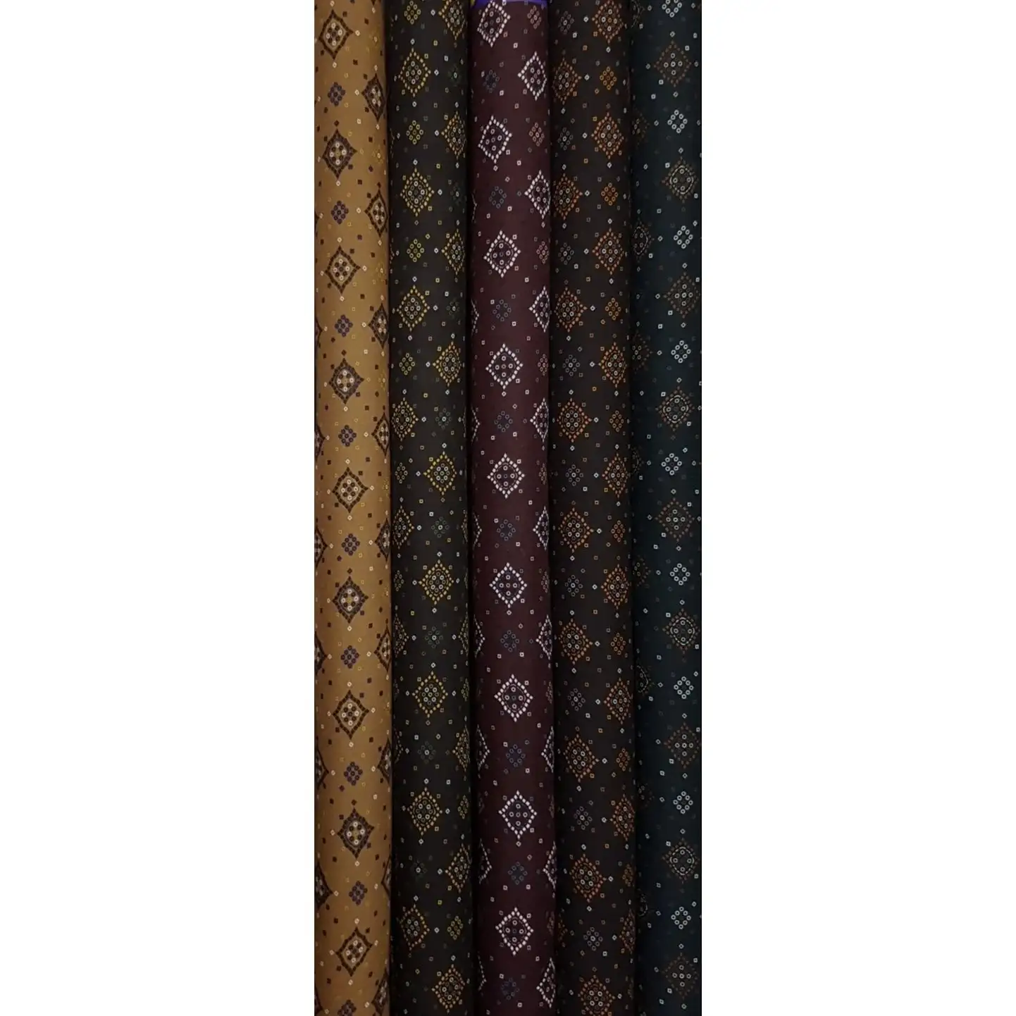Geometric12 Collection, all colorways shown together. Concentric diamond medallions built from tiny dotted squares repeat in tidy rows across a finely speckled ground.