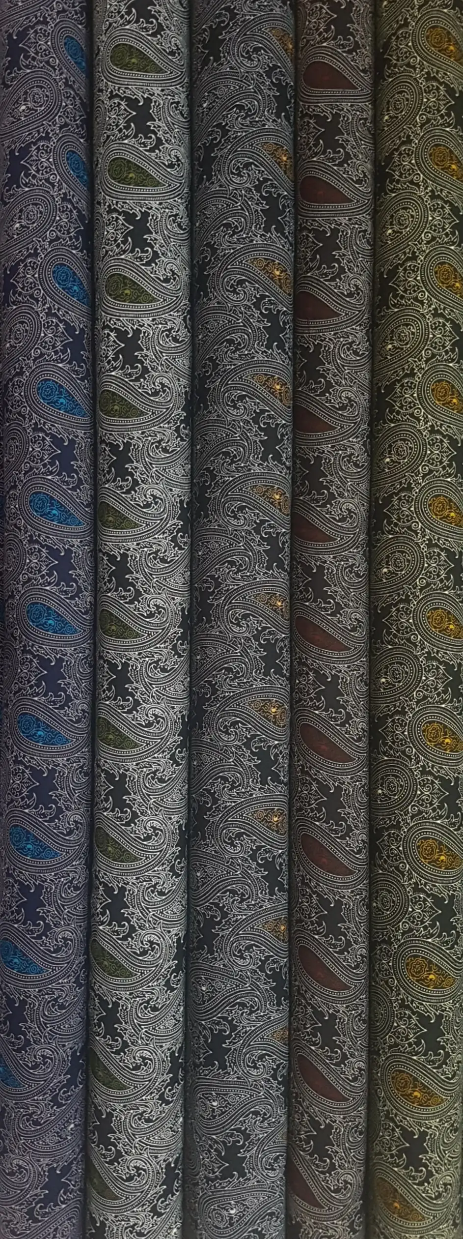 Geometric16 Collection, all colorways shown together. Ornate paisley teardrops and curling botanical leaves repeat across a densely scrolled background.