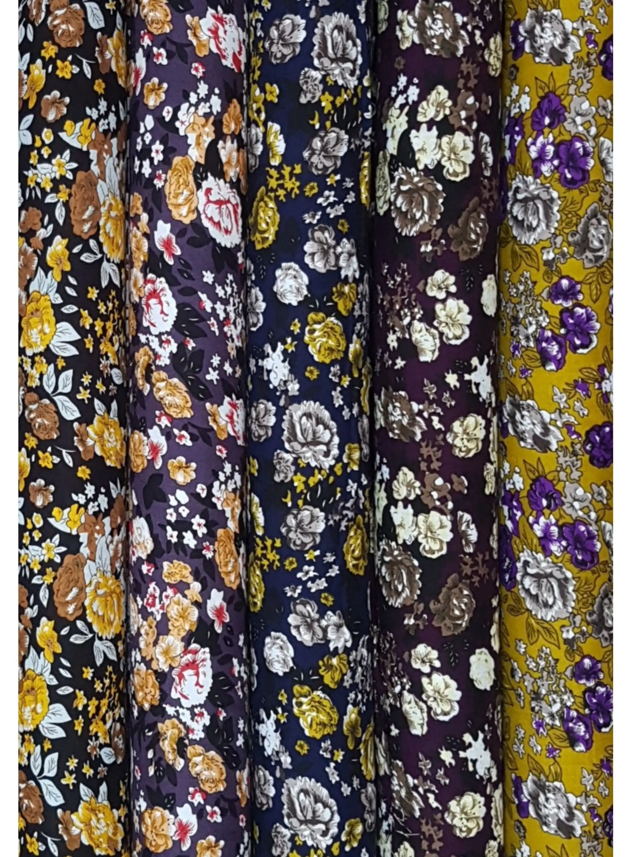 Floral9 Collection, all colorways shown together. A dense floral spray of full-blown roses and tiny scattered buds winds through small leaves.
