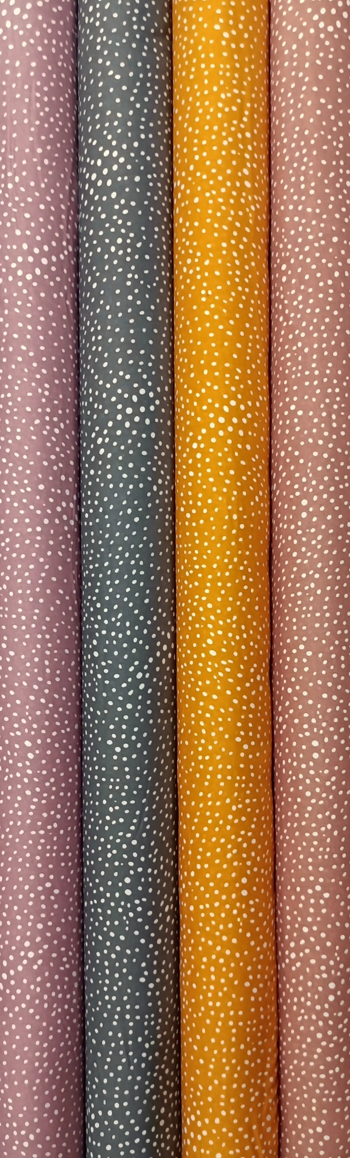 Stripes and Dots21 Collection, all colorways shown together. Small irregular dots scatter densely across the fabric like flecks of falling snow.