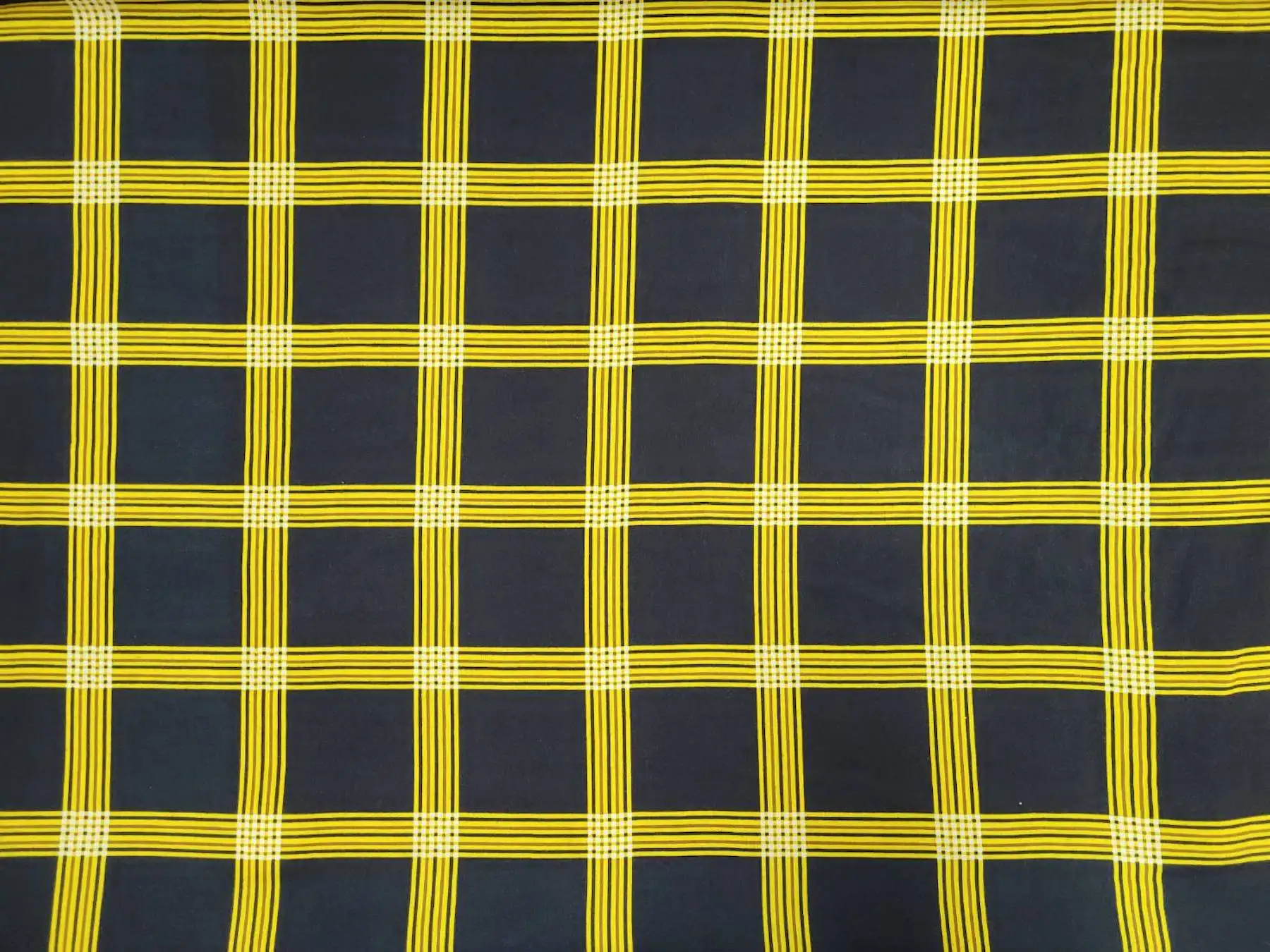 Stripes and Dots10 Collection in Black And Yellow. Black ground crossed by golden-yellow stripe clusters forming a bold open windowpane grid.