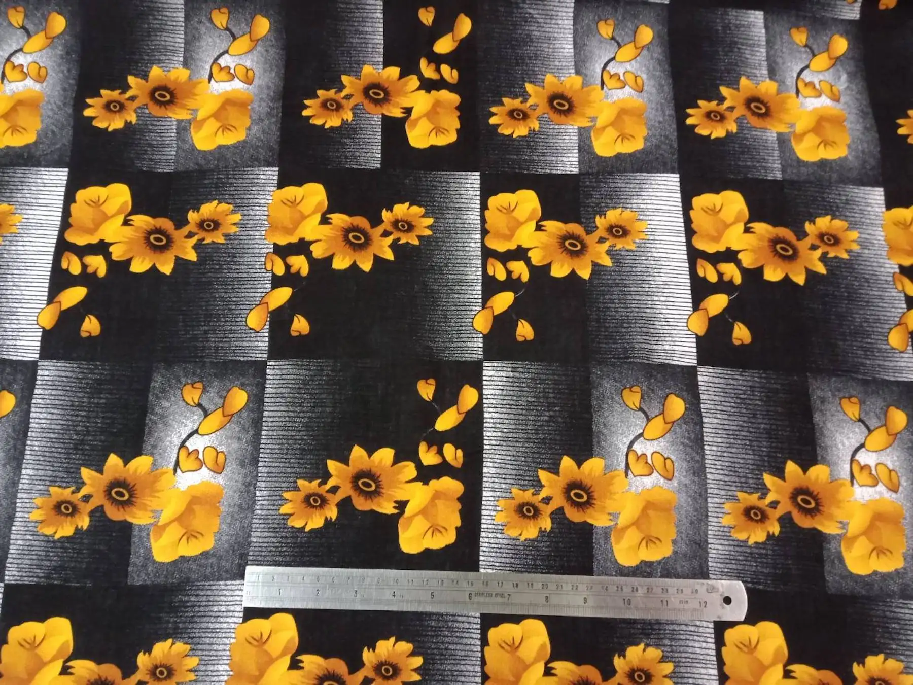 Floral16 Collection in Black. Charcoal-and-black striped ground carries golden-yellow sunflower blooms with dark seeded centers.
