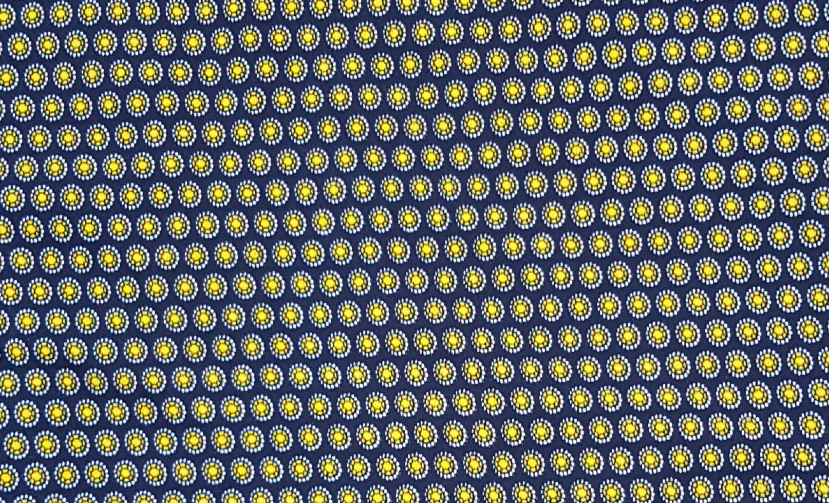 Stripes and Dots13 Collection in Blue. Deep navy ground tiled with rows of golden-yellow and pale dots in a honeycomb grid.