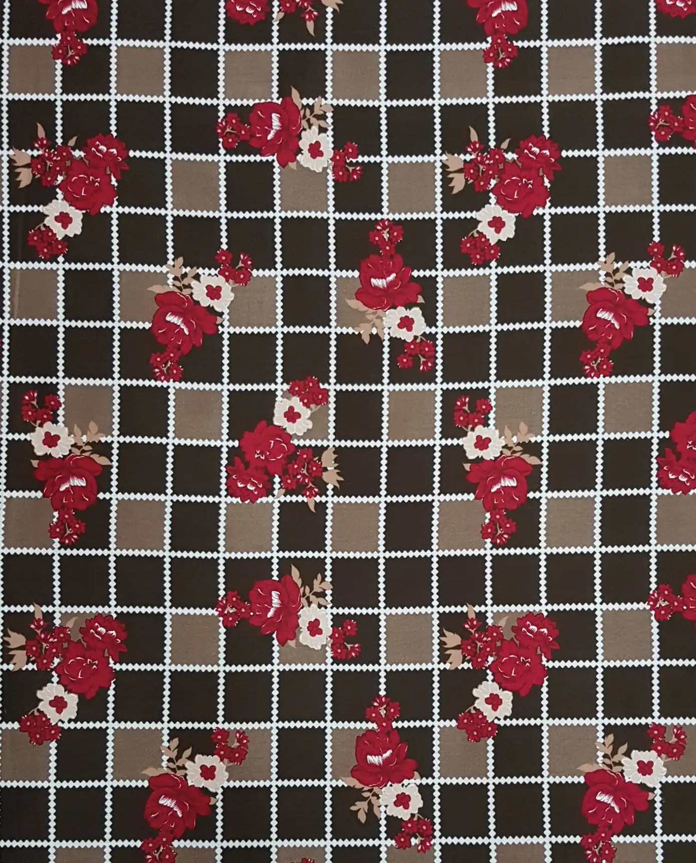 Floral7 Collection in Brown. Warm brown ground with a tan grid, dotted with golden-yellow and rust flower clusters and green leaves.