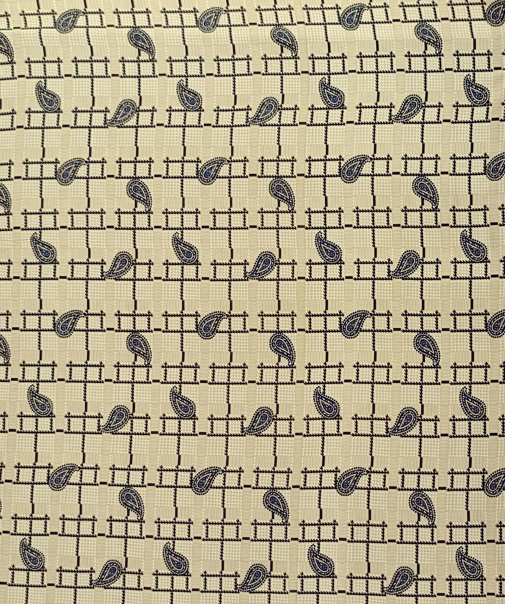 Geometric7 Collection in Cream. Pale cream ground with a faint tan check, dark brown windowpane lines and brown paisley drops.