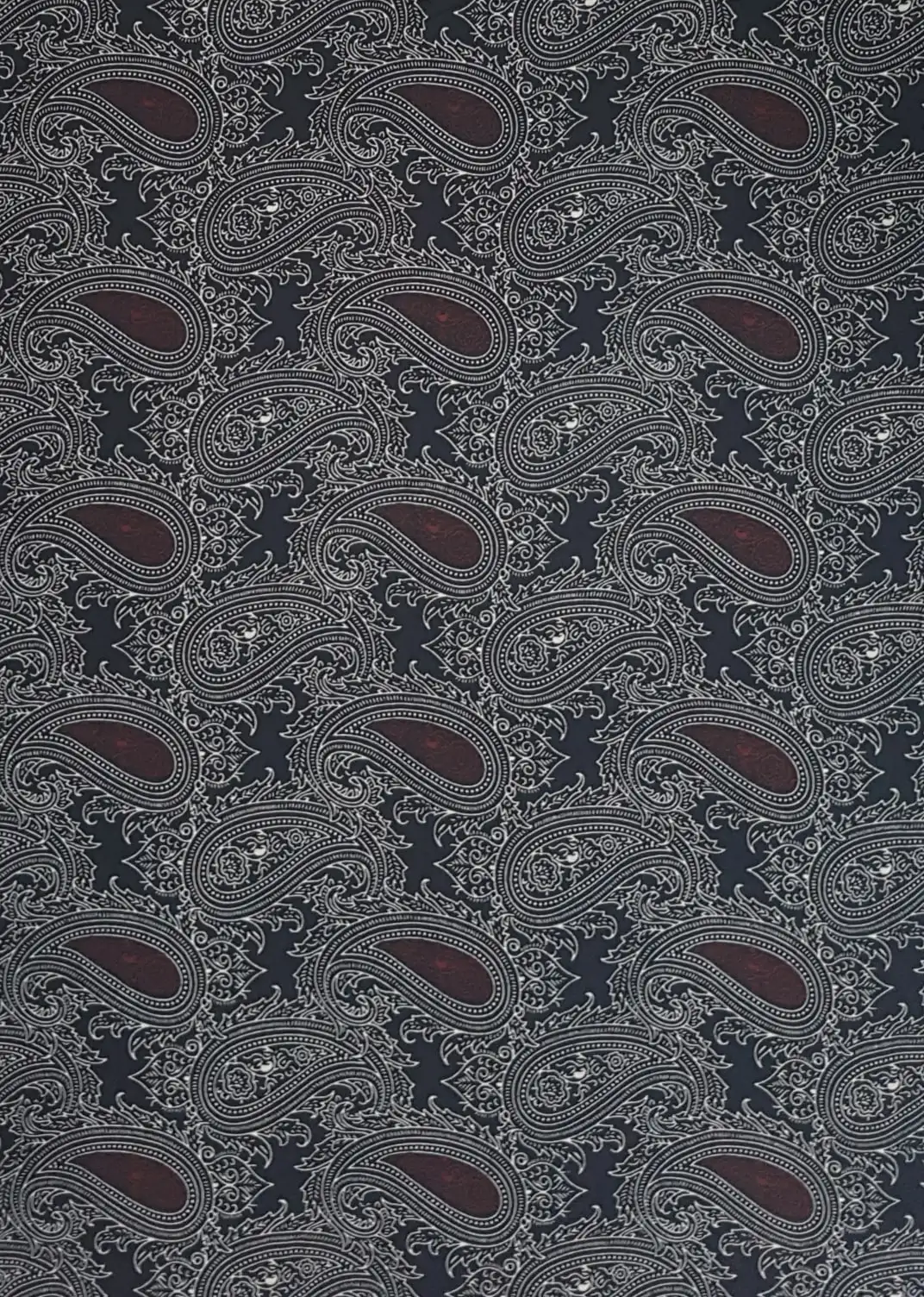 Geometric16 Collection in Brown. Soft grey-taupe ground carrying charcoal paisley outlines with warm golden-brown filled motifs.