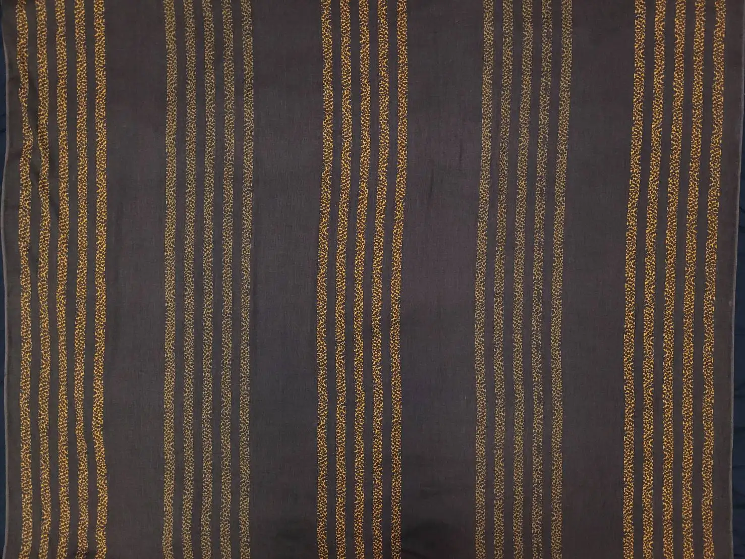 Stripes and Dots11 Collection in Cream Brown. Warm taupe-brown ground with horizontal bands of mustard-yellow and dark speckled dots.