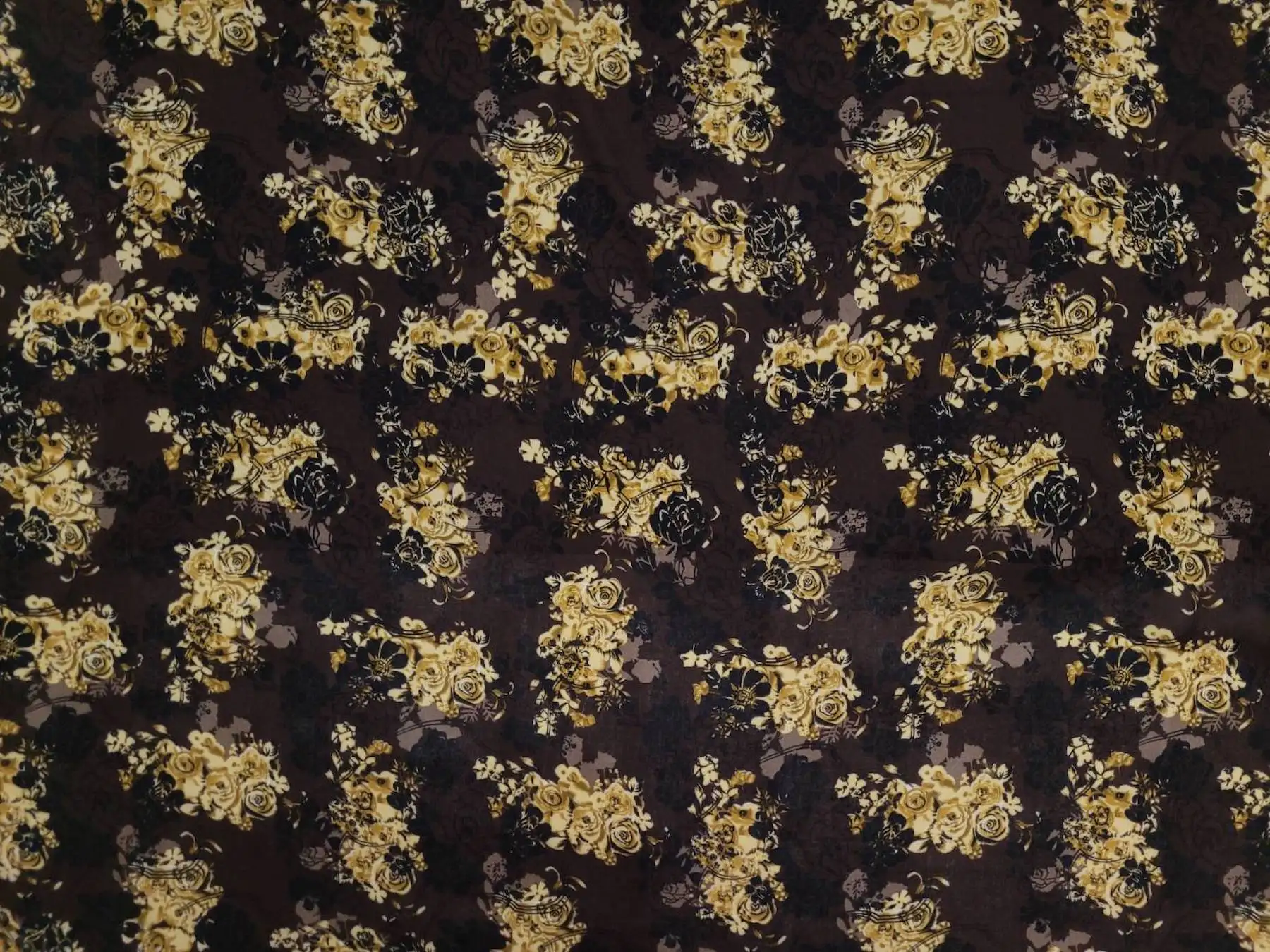 Floral10 Collection in Dark Brown. Deep chocolate-brown ground carrying soft sage-green roses and ivory blossoms on shadowy vines.