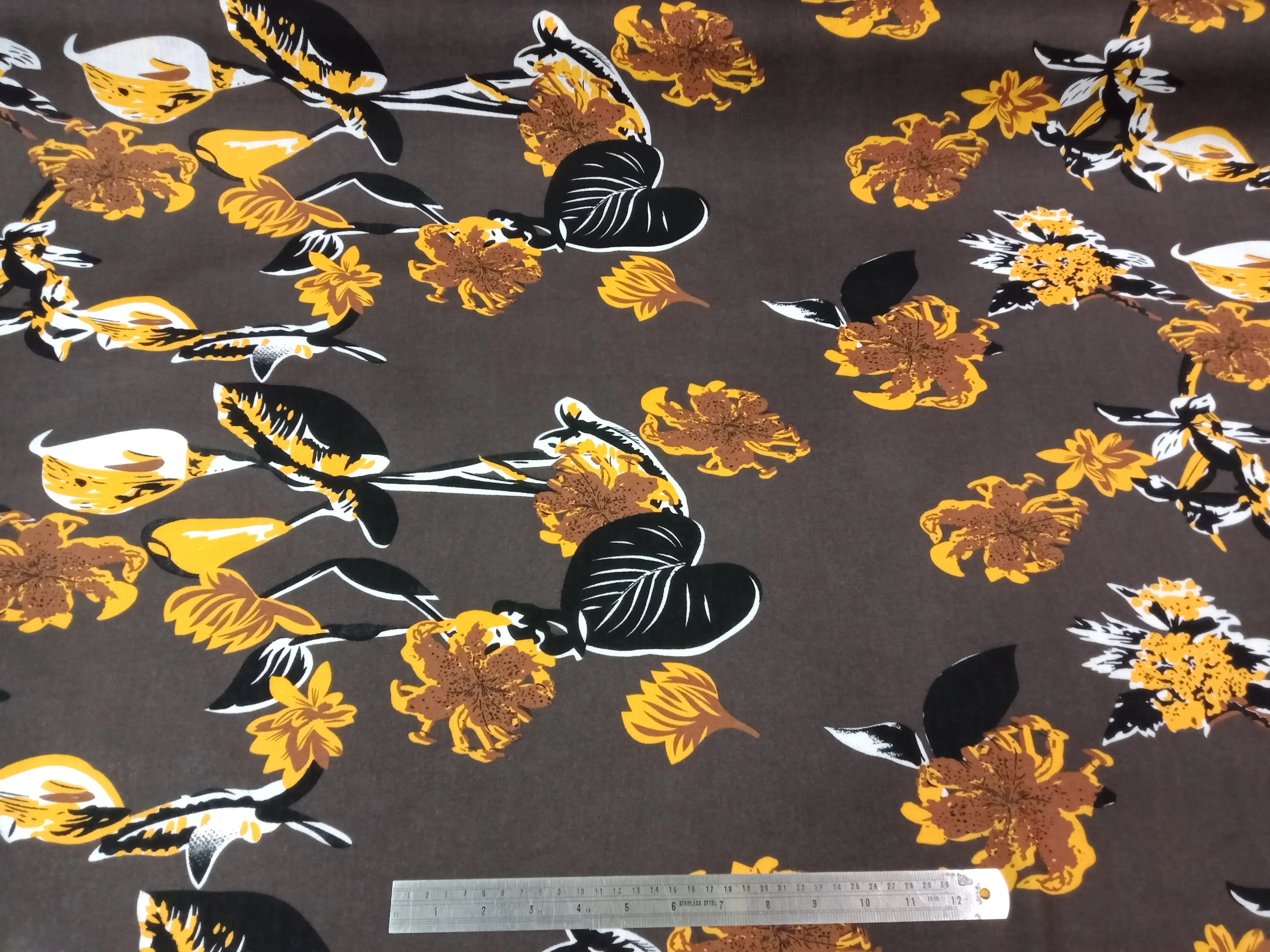 Floral8 Collection in Floral Grey. Dark brown ground carrying golden-yellow tulips and rust-orange lilies on leafy vines.