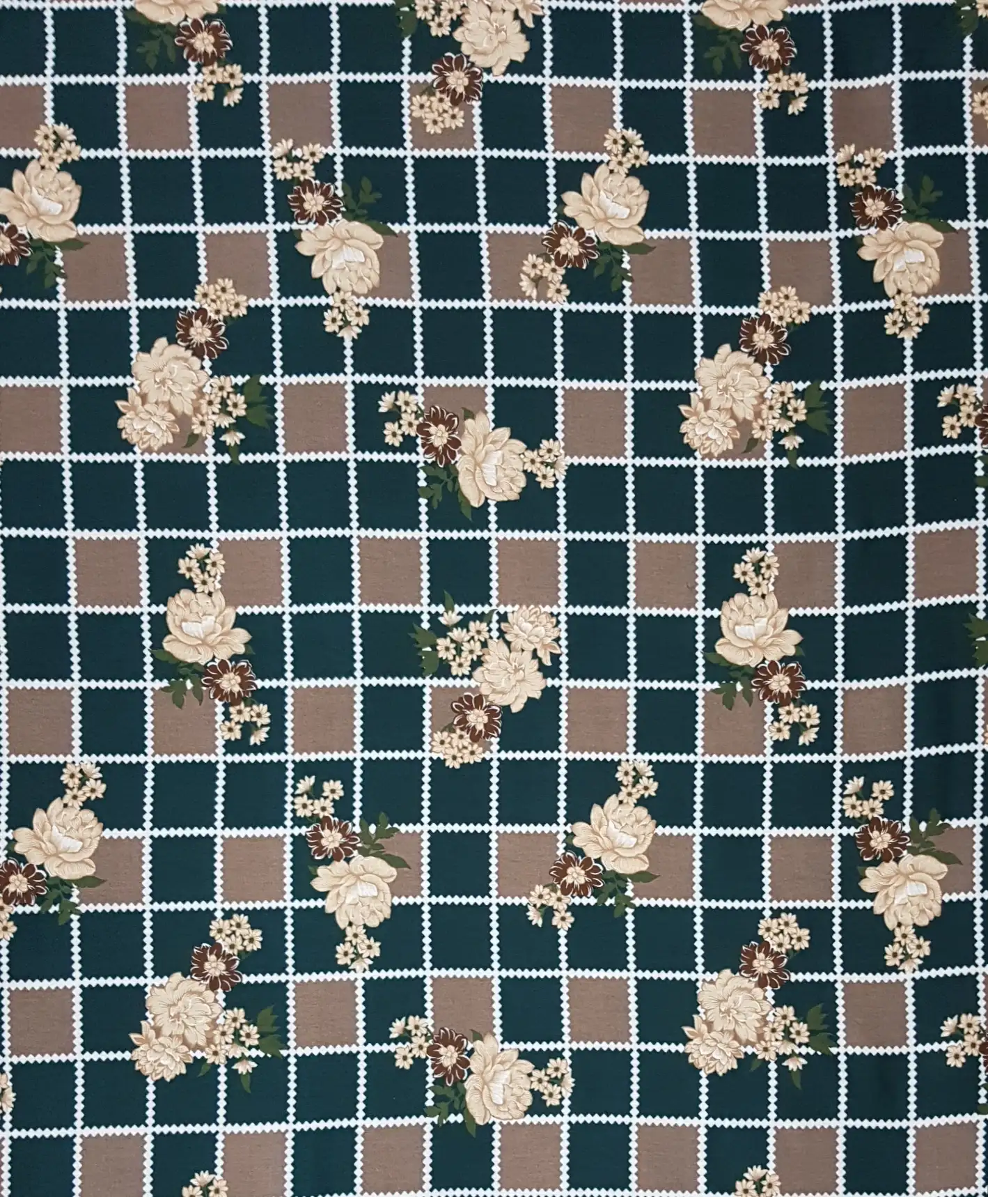 Floral7 Collection in Green Cream. Deep forest-green ground crossed by cream lattice lines, scattered with pale cream and soft pink blooms.