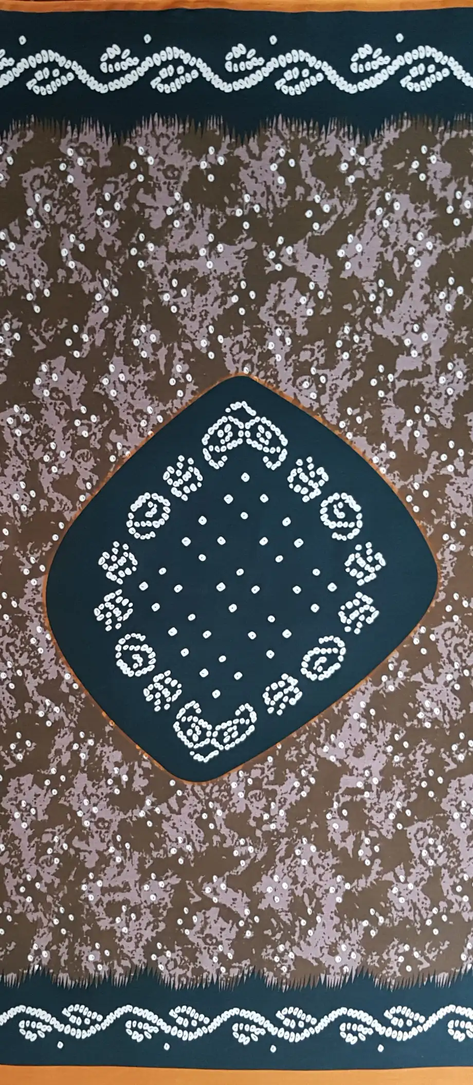 Geometric8 Collection in Green. Teal-green ground flecked with taupe and white dots, framing dark dotted swirls and pale paisley trim.