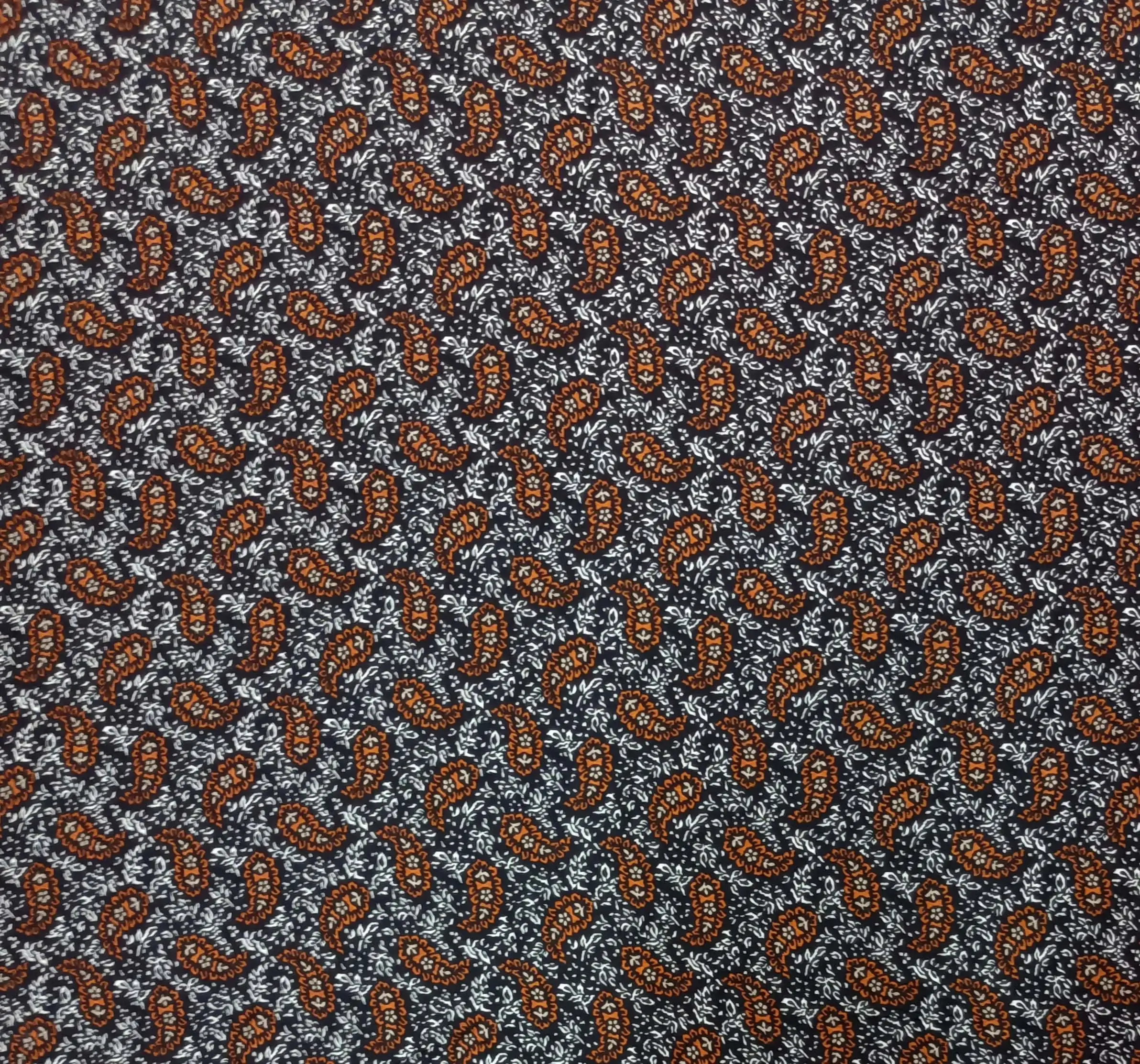 Geometric1 Collection in Orange. Charcoal-black ground with warm rust-orange paisleys and cream vines threading through the print.