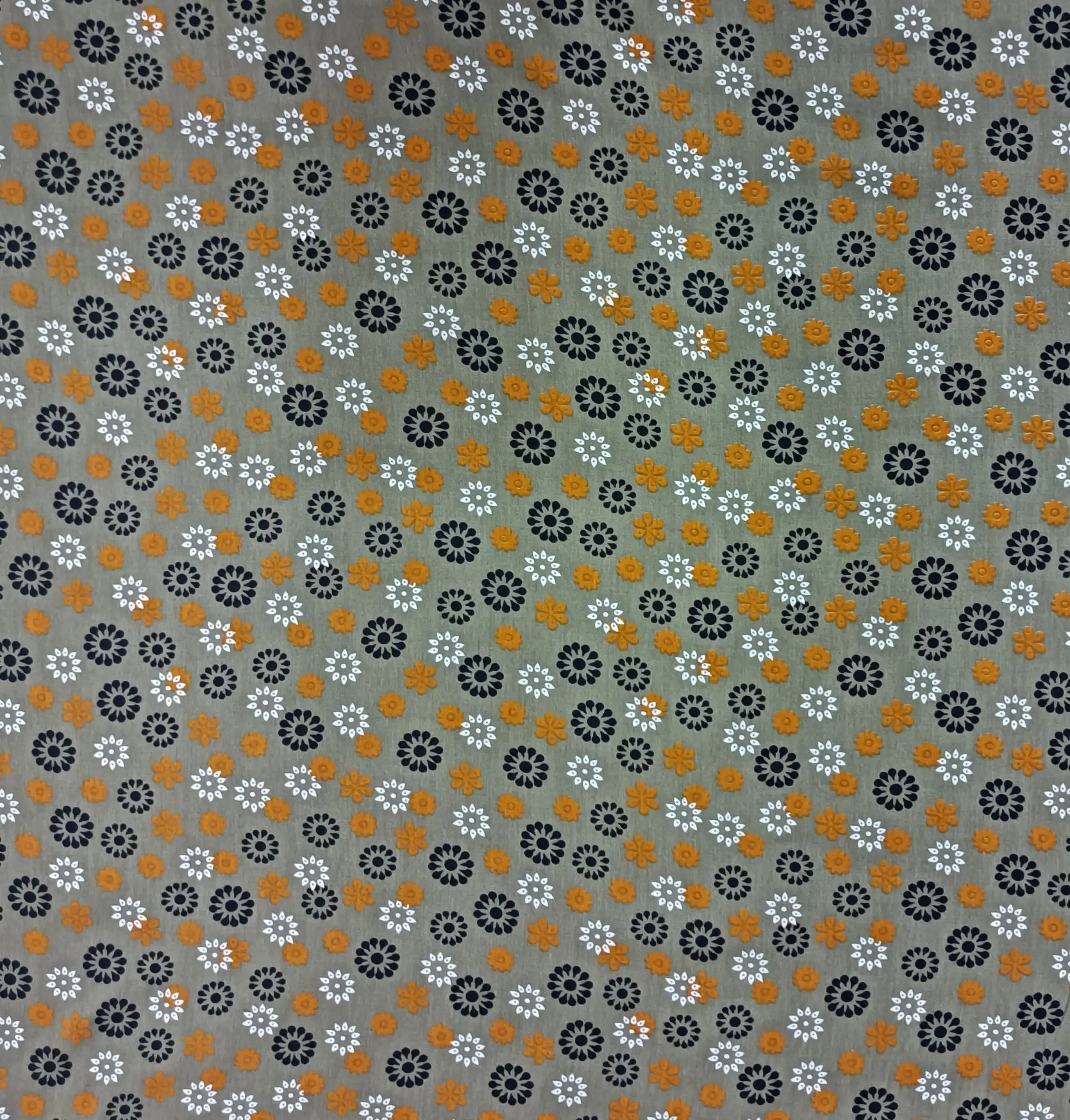 Floral2 Collection in Green. Dark brown ground scattered with golden yellow, cream, and grey starburst daisies throughout.