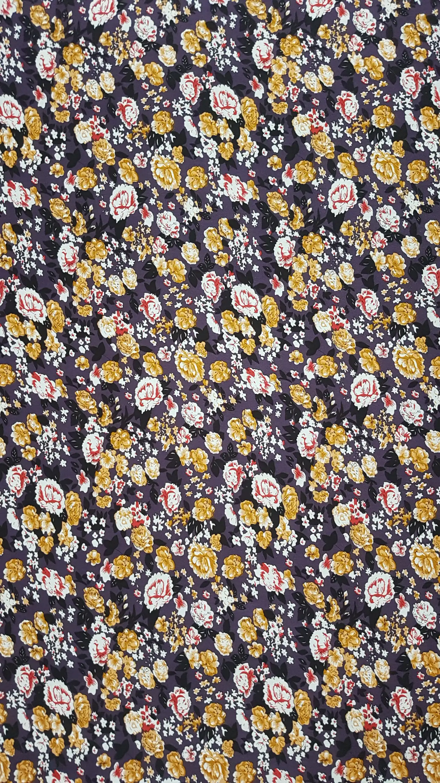 Floral9 Collection in Purple Orange Flowers. Plum-purple ground scattered with rust-orange and cream roses plus red-flecked little flowers.