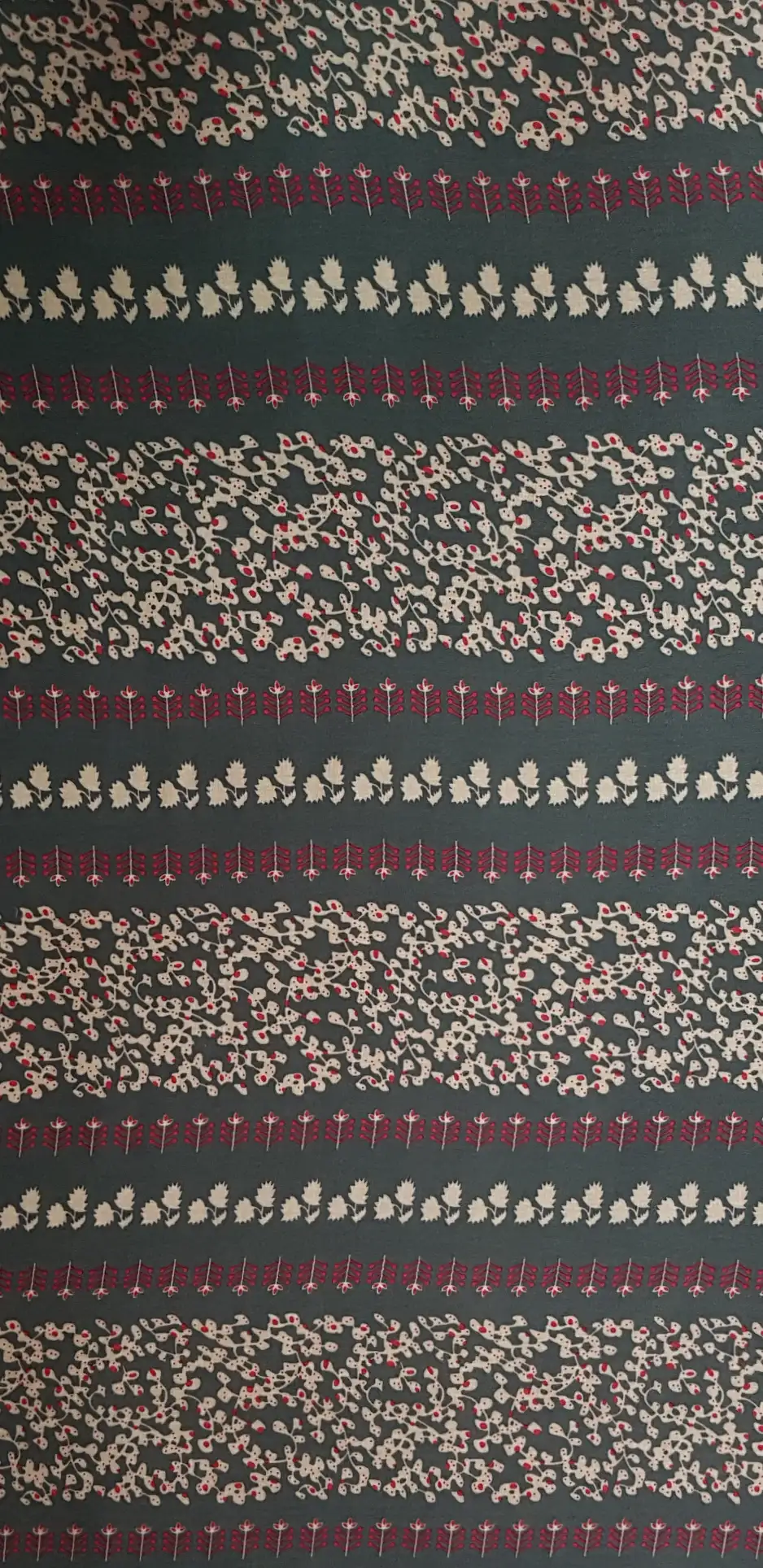 Floral15 Collection in Red. Charcoal-grey ground with tan-beige sprigs and brick-red potted plant rows running across it.
