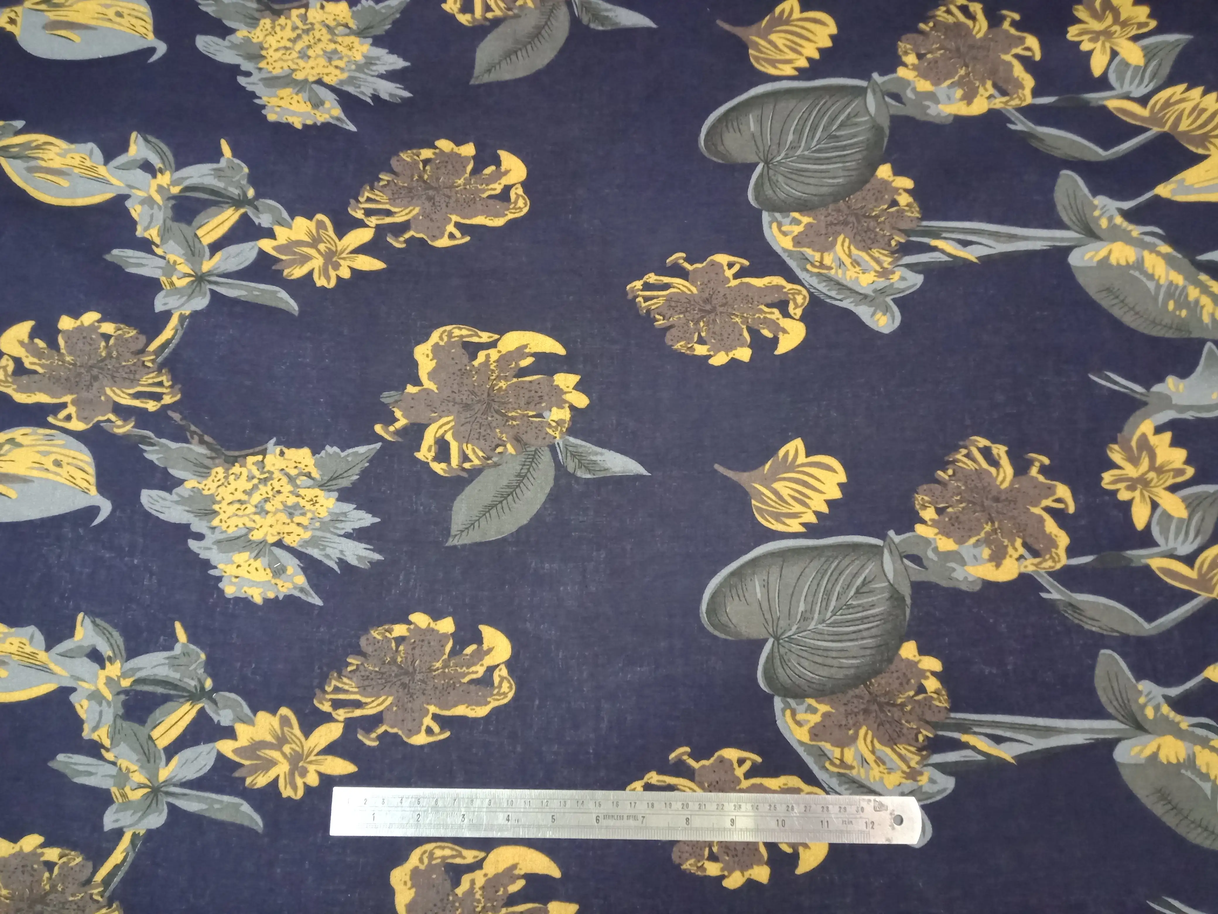 Floral8 Collection in Floral Yellow. Inky dark ground scattered with golden-yellow and amber blossoms and brown leaves.