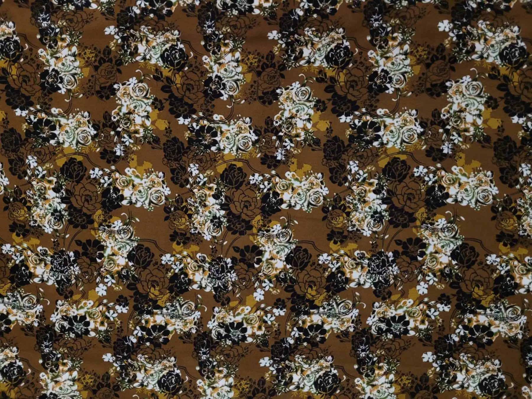 Floral10 Collection in Light Brown. Warm tan and brown ground showing golden-beige blooms and dusty-rose flowers on leafy stems.