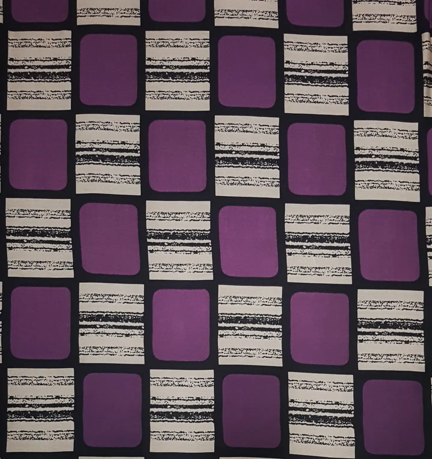 Geometric10 Collection in Purple. Plum-purple blocks on black, separated by sandy beige and charcoal distressed horizontal striping.
