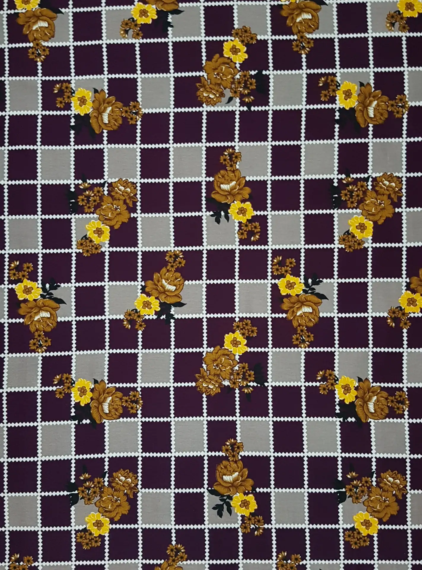 Floral7 Collection in Purple. Rich aubergine-purple ground with a lavender grid, strewn with white, pink, and gold blossoms.