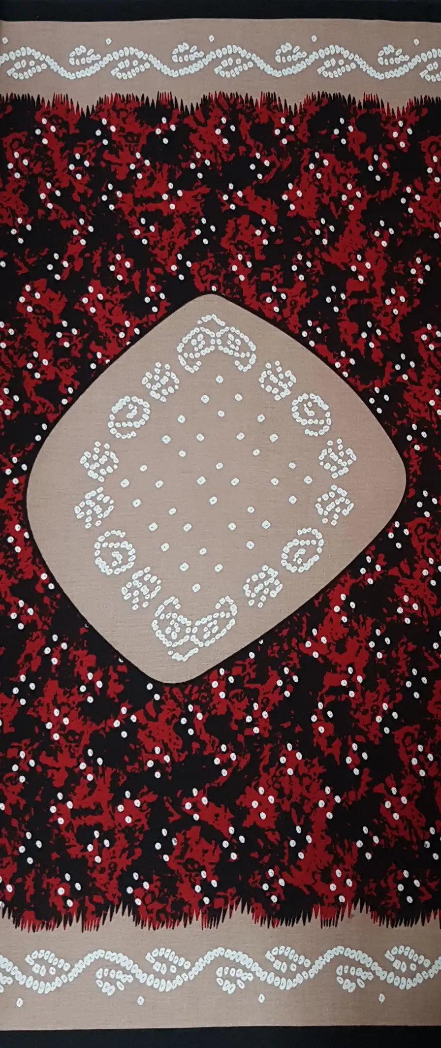 Geometric8 Collection in Red. Dusty mauve ground sprinkled with white, surrounding a black center filled with white spiral and dotted shapes.
