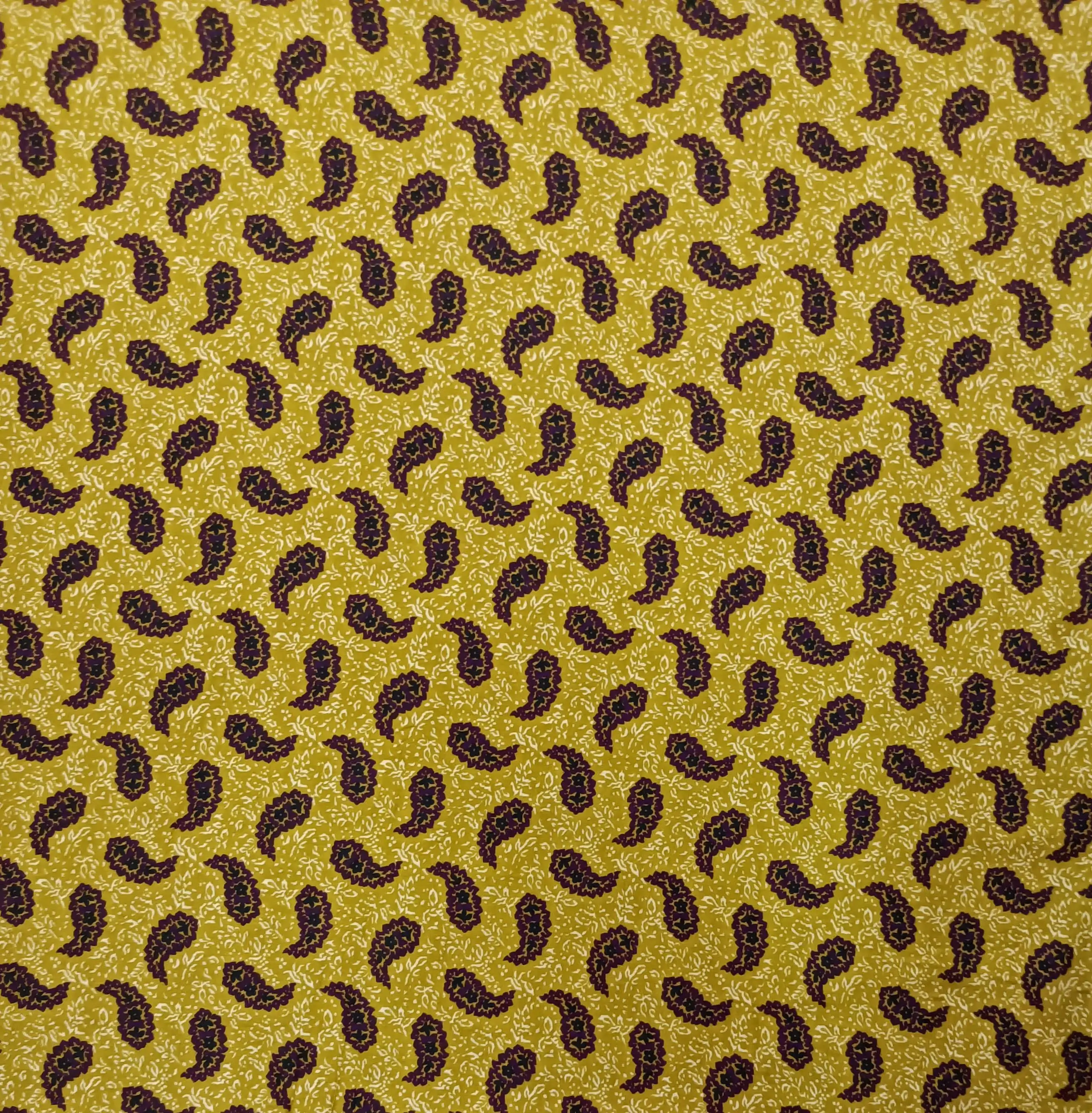 Geometric1 Collection in Yellow. Slate-grey ground scattered with burnt-amber paisleys and soft yellow and ivory leafy sprigs.