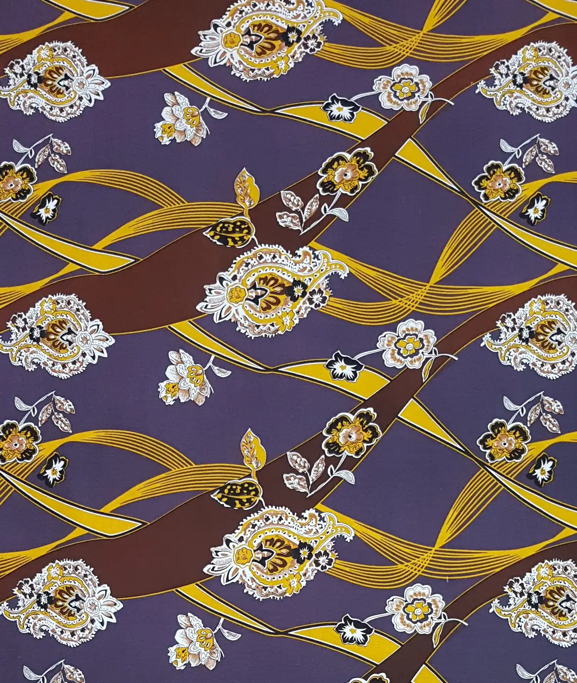 Floral22 Collection in Purple. Plum-purple background patterned with cream florals, lilac buds and grey-green leaf trails.