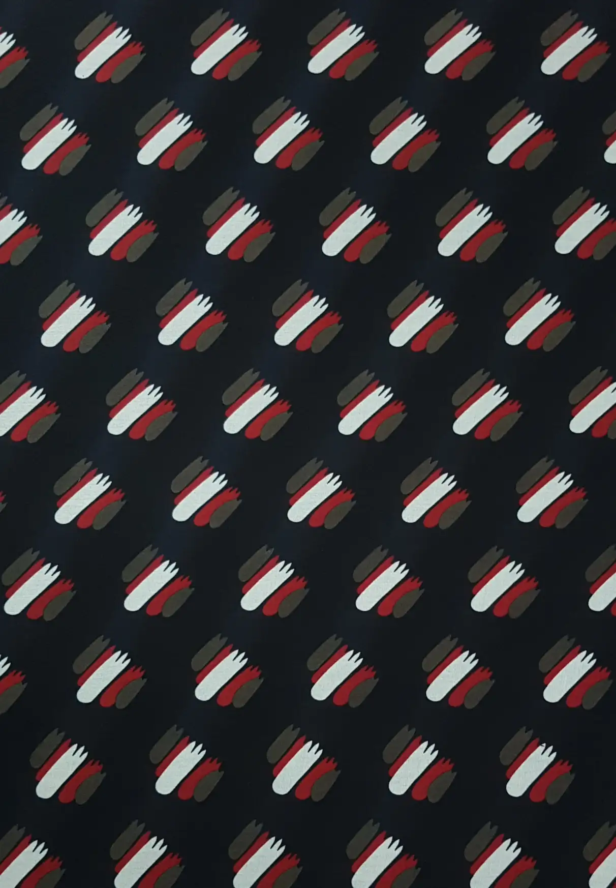 Geometric5 Collection in Red. Deep navy-black ground sprinkled with red, white and grey striped rectangular tiles.