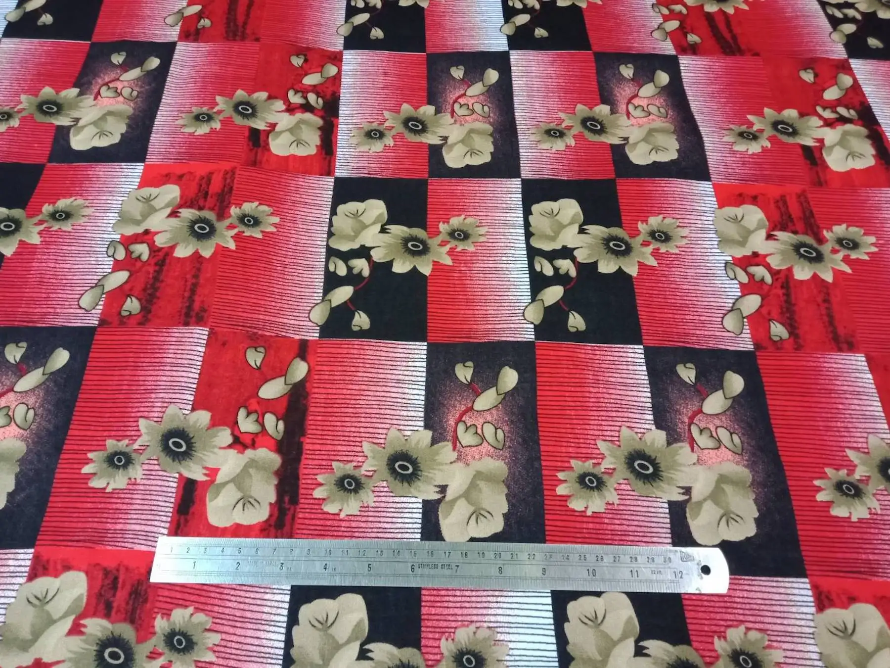 Floral16 Collection in Red. Bright red and black blocks hold pale beige blossoms with dark, ringed centers.