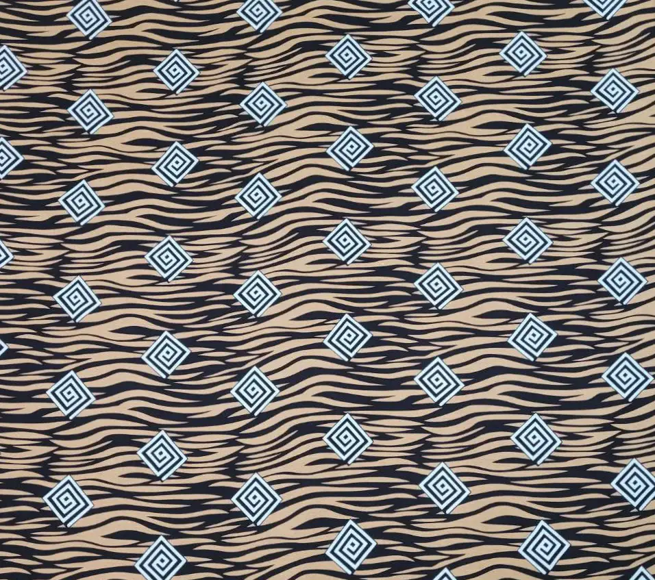 Stripes and Dots17 Collection in White. Black-and-white striped ground holds brown and blue square-spiral medallions in alternating rows.