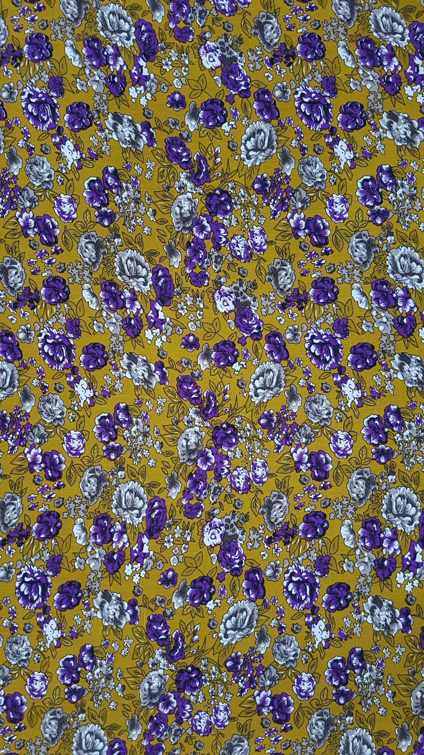 Floral9 Collection in Yellow. Bright mustard-yellow ground showing violet-purple blooms and grey-white roses with green leaves.