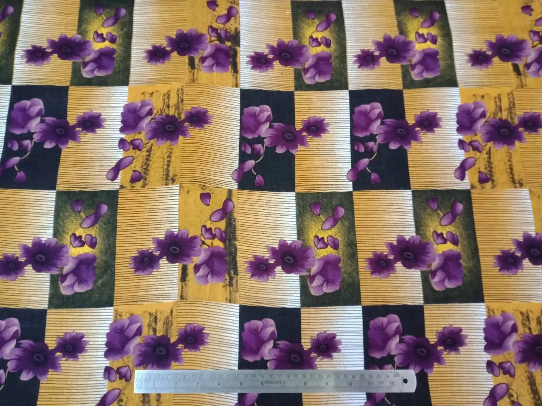 Floral16 Collection in Yellow. Mustard-yellow ground with vivid purple daisy flowers and violet petals on grey banding.
