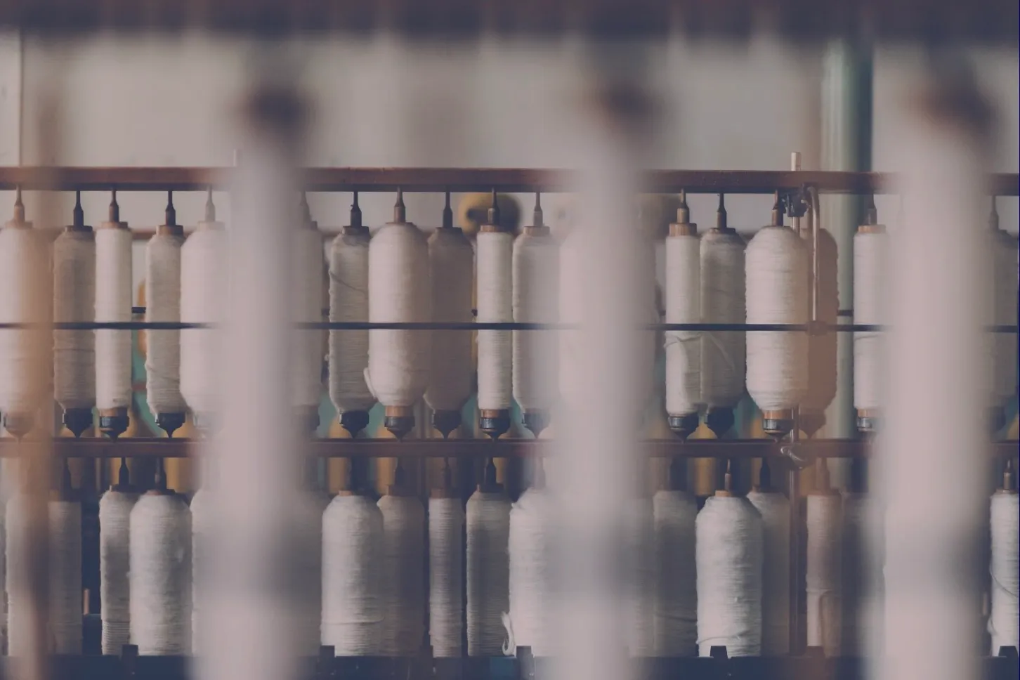 Rows of rayon thread spools on a production line